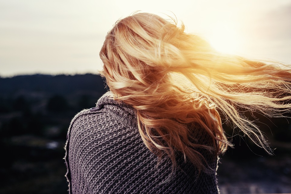 Blond-haired girl against the setting sun.