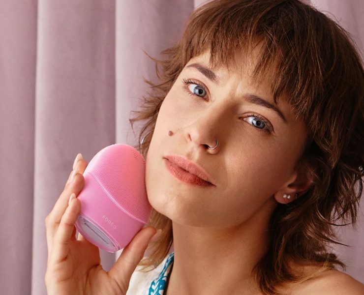 Woman using FOREO LUNA skincare device