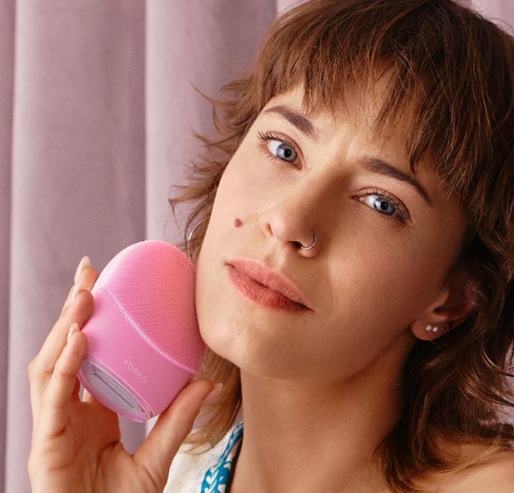 Woman using FOREO LUNA skincare device